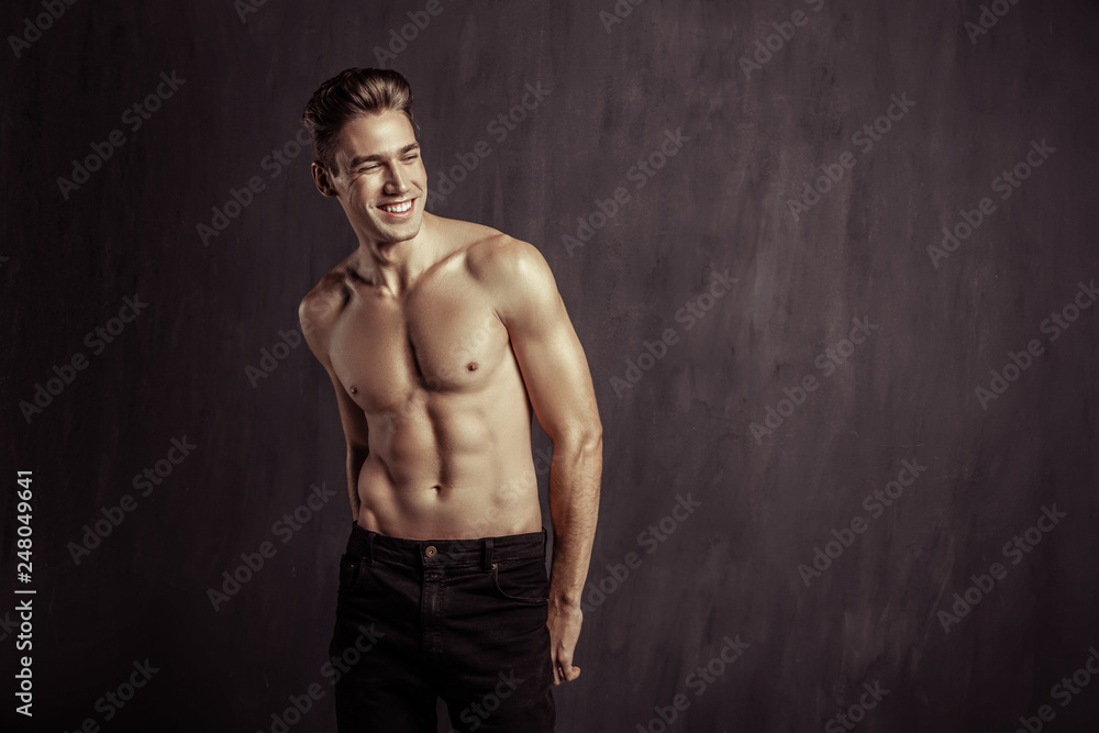 Fototapeta premium Positive joyful young man showing his emotions