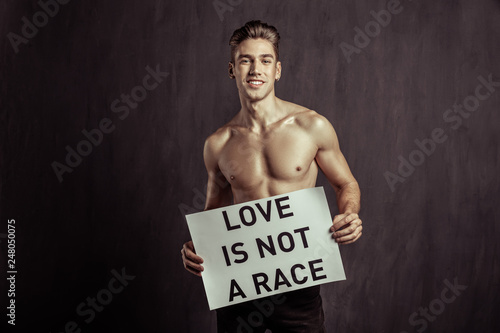Joyful handsome young man being against racism