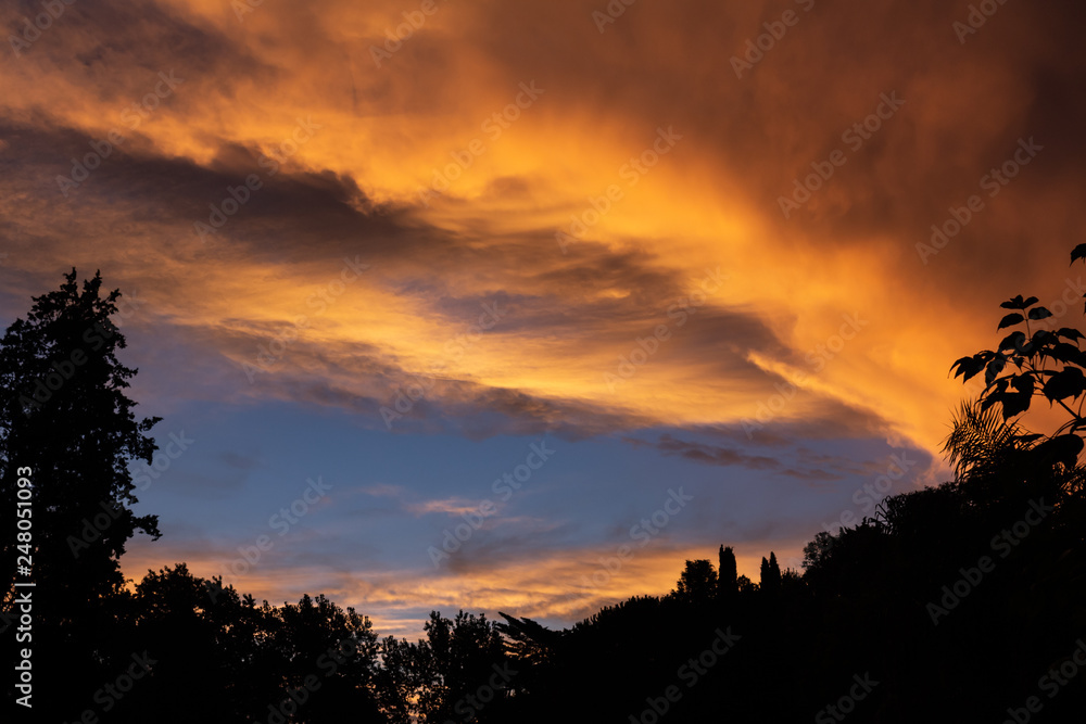 Fototapeta premium Storm clouds during sunset dyed golden colors. Climate change concept.