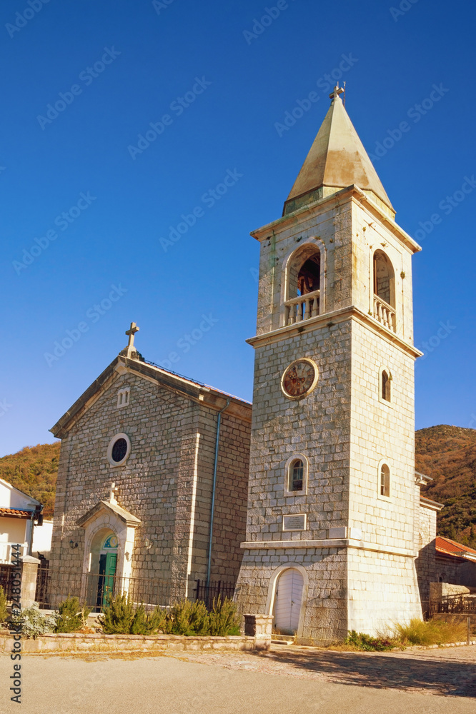Religious architecture. Village church in Mediterranean. Montenegro, Tivat. View of Catholic Church of Saint Roch in Donja Lastva village on sunny winter day