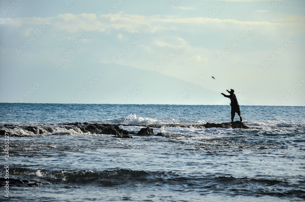 Fisherman fishing on the sea.