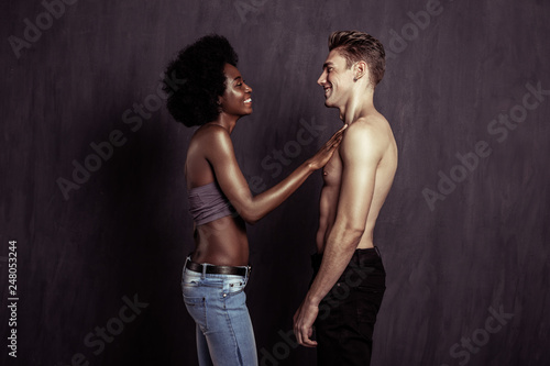 Positive afro American woman touching her boyfriend