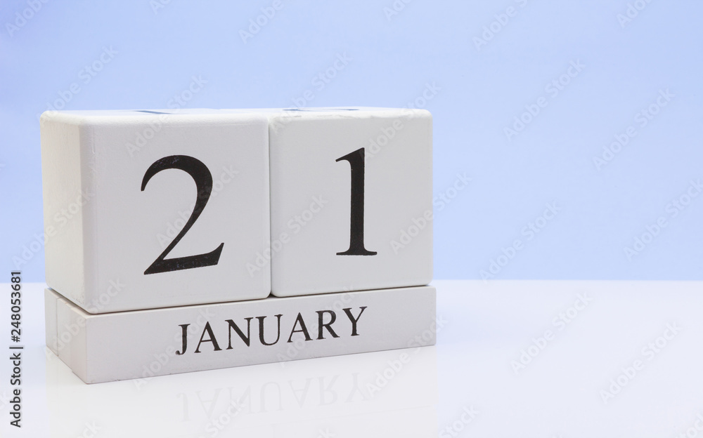 January 21st. Day 21 of month, daily calendar on white table with reflection, with light blue background. Winter time, empty space for text January 21st. Day 21 of month, daily calendar on white table with reflection, with light blue background. Winter time, empty space for text