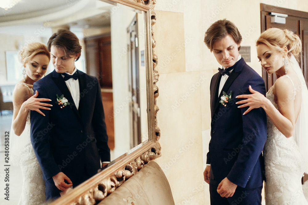stylish bride and groom posing at big mirror in hotel room. happy luxury wedding couple embracing and hugging. romantic sensual moment. mirror reflection Stock Photo | Adobe Stock Stylish Bride And Groom Posing At Big Mirror In Hotel Room. Happy Luxury Wedding Couple Embracing And Hugging. Romantic Sensual Moment. Mirror Reflection Stock Photo | Adobe Stock