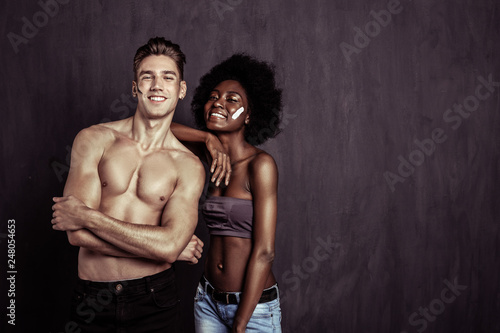 Delighted multiethnic young couple feeling great together