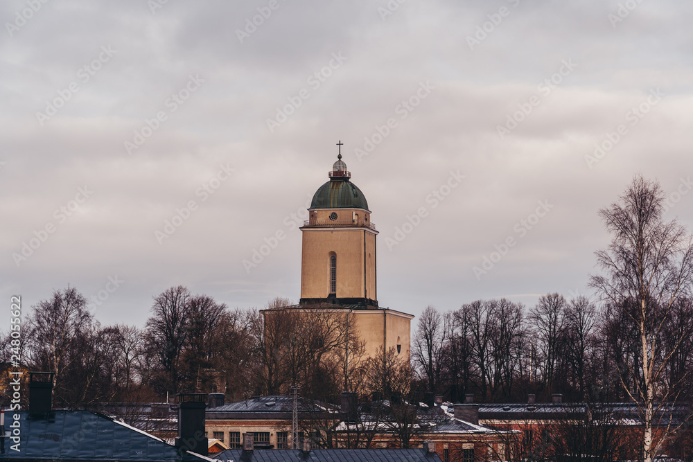 Old lighthouse and church in a winter or spring day, Helsinki Finland Old lighthouse and church in a winter or spring day, Helsinki Finland