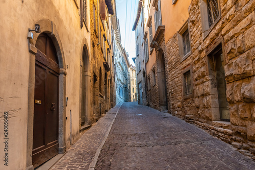 Beautiful Old narrow street of small medieval city Citta Alta, perspective of street in Bergamo, Italy © pszabo