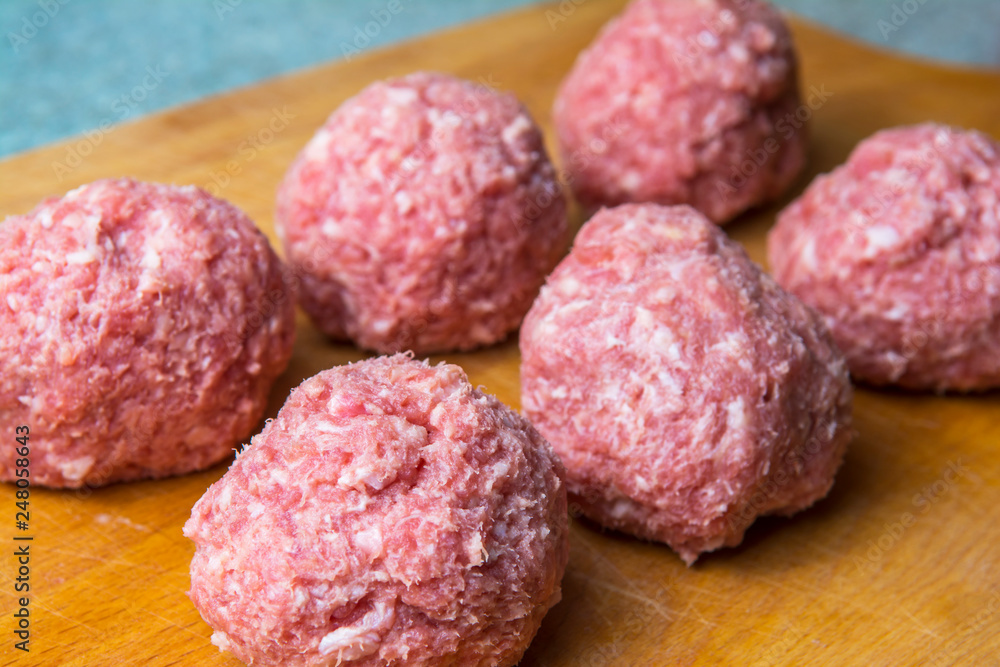 raw mince patties in a cooking . cutlets are prepared for cutting board raw mince patties in a cooking . cutlets are prepared for cutting board
