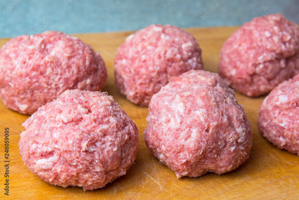 raw mince patties in a cooking . cutlets are prepared for cutting board raw mince patties in a cooking . cutlets are prepared for cutting board