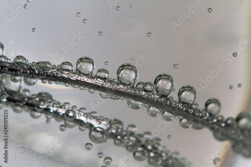 Air bubbles under the water on wire closeup