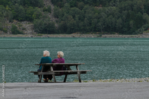 Eldery tourist relax by the bank of the fishing village of Skjolden - Norway