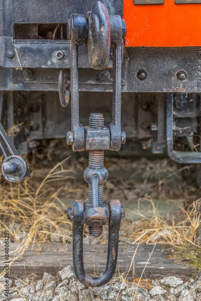 Detailed view of a old wagon stretcher, rusty pieces antique system Detailed view of a old wagon stretcher, rusty pieces antique system