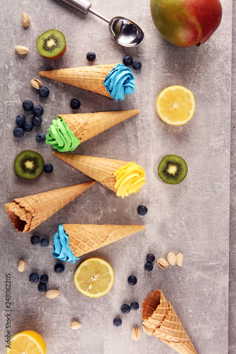 Fototapeta Naklejka Na Ścianę i Meble -  Vanilla frozen yogurt or colorful soft ice cream in waffle cone.
