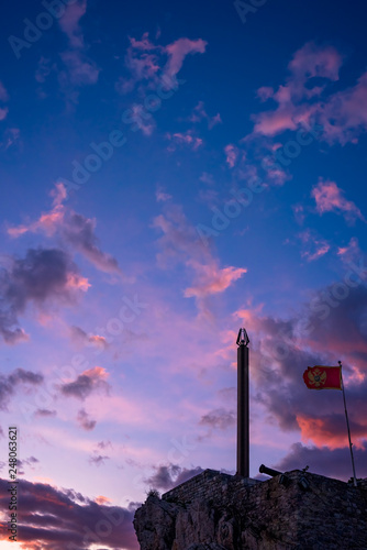 Obelisk and flag on the cliffs at dusk
