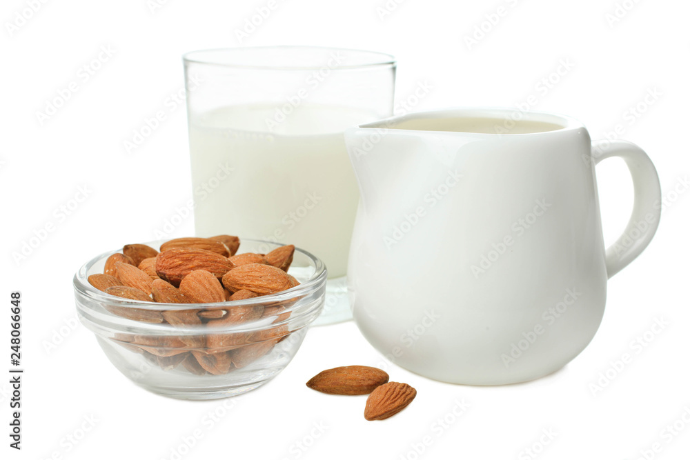 Glass of milk, milk jar and almond nuts Glass of milk, milk jar and almond nuts