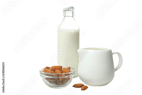 Glass bottle with milk, milk jug and almond nuts