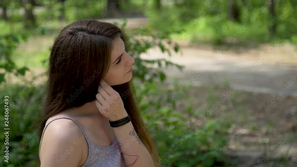 Close up beautiful girl puts on headphone Close up beautiful girl puts on headphone
