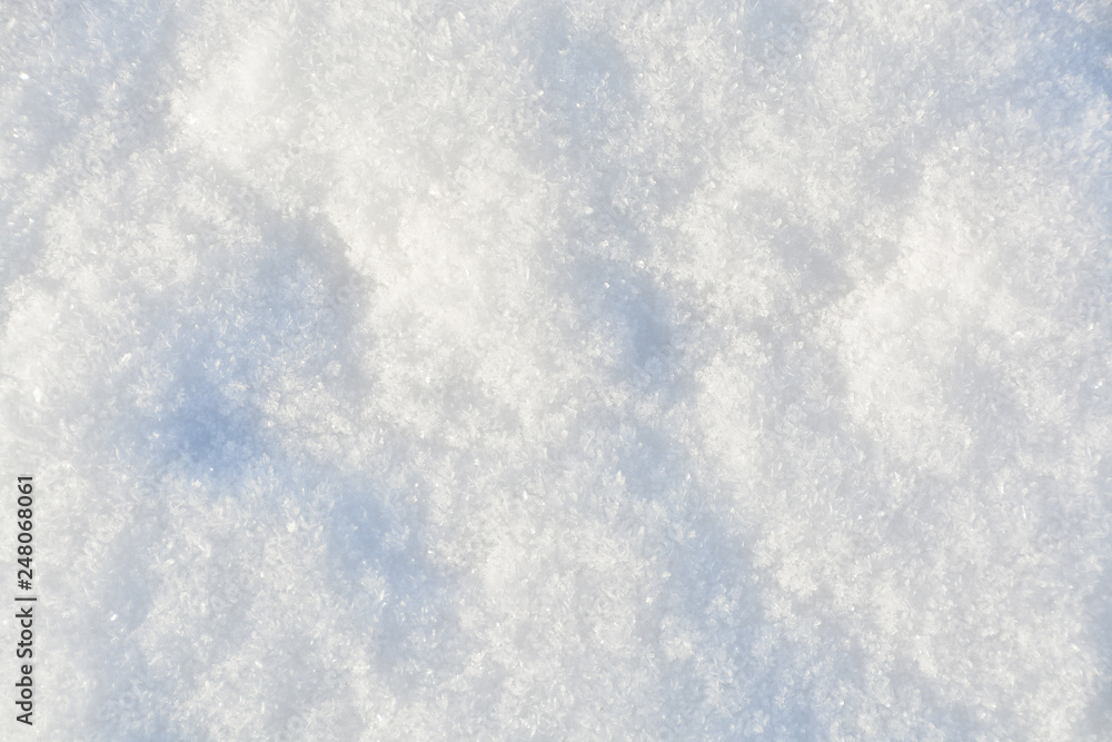 White crystals of snow on flat surface. Texture background