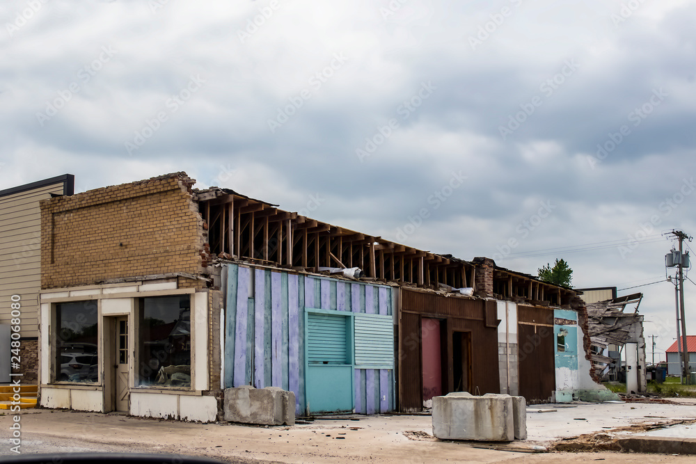 Old storefront in American small town showing walls where another building has been demolished with interior walls visible - very grungy Old storefront in American small town showing walls where another building has been demolished with interior walls visible - very grungy