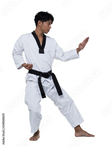 Master Black Belt TaeKwonDo handsome man instructor Teacher fighter show hit pose, studio lighting white background isolated.  White formal fighting suit, motion blur hand foots on taekwondo post. photo