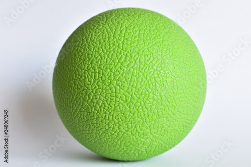 Green lacrosse ball closeup with rough surface pattern