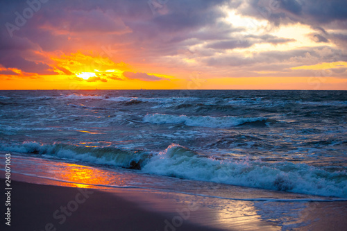 beautiful sunset view over the sea with bright colorful clouds