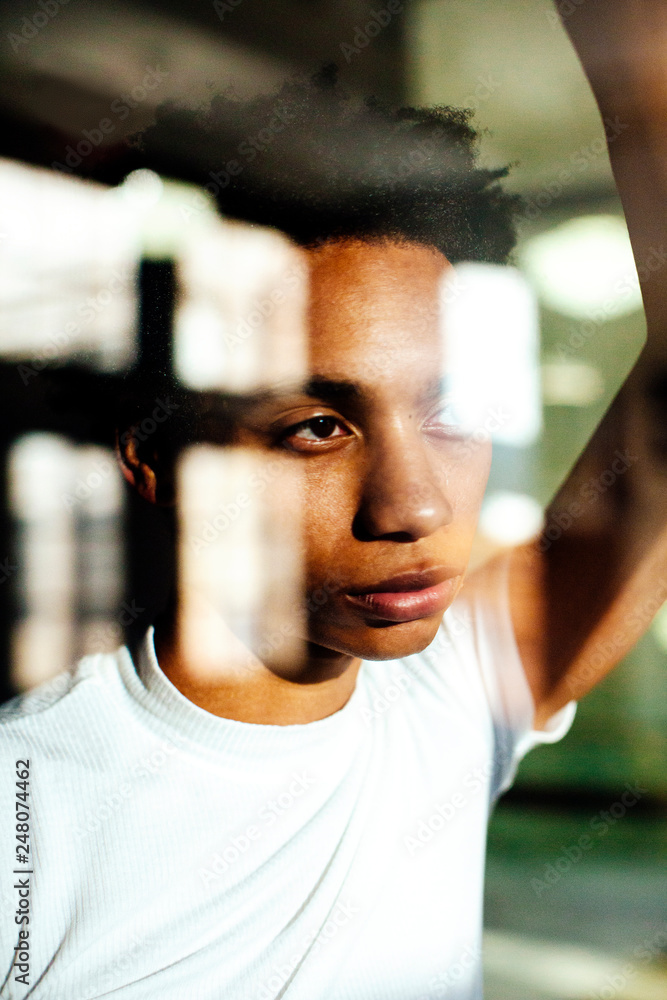 Portrait of a serious young man looking out the window Portrait of a serious young man looking out the window