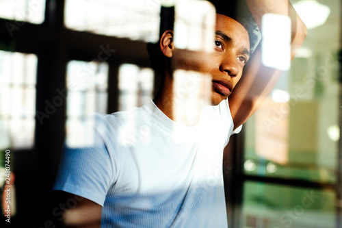 Portrait of a young millennial man looking out the window