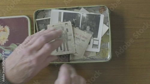 Senior caucasian man looking through a memory box themes of memories nostalgia old