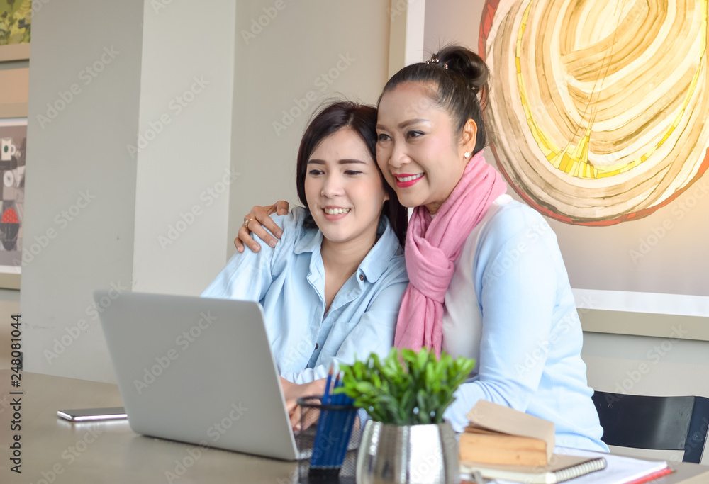 Daughter is teaching the elderly to study using the laptop. concept Senior couples use of laptop for digital online. Daughter is teaching the elderly to study using the laptop. concept Senior couples use of laptop for digital online.