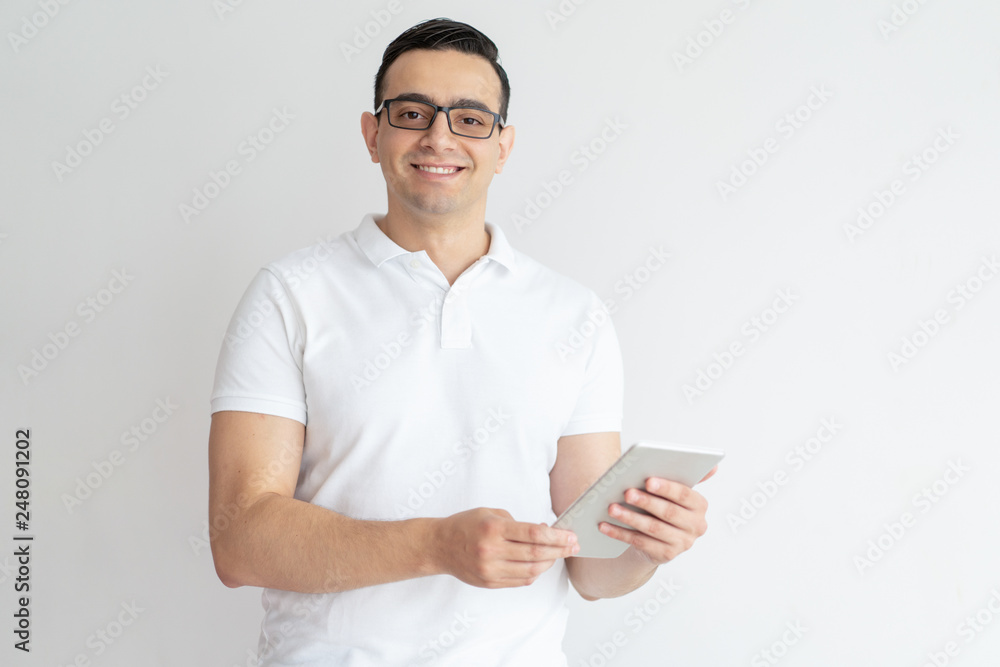 Smiling young man using tablet computer Smiling young man using tablet computer