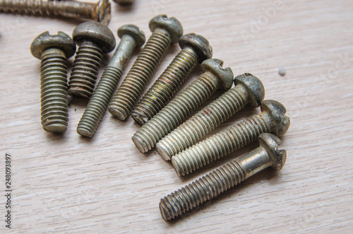 old nails and bolts are scattered on the table