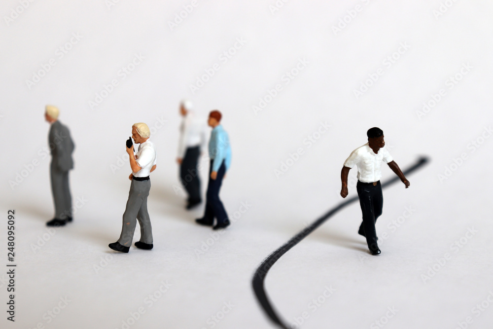 The concept of racial discrimination within the organization. Miniature people. The concept of racial discrimination within the organization. Miniature people.