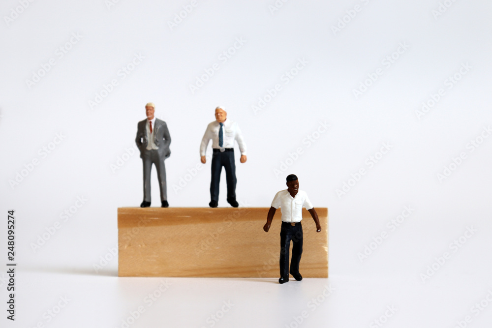 Miniature people standing on tree blocks and miniature man standing under tree blocks. Miniature people standing on tree blocks and miniature man standing under tree blocks.