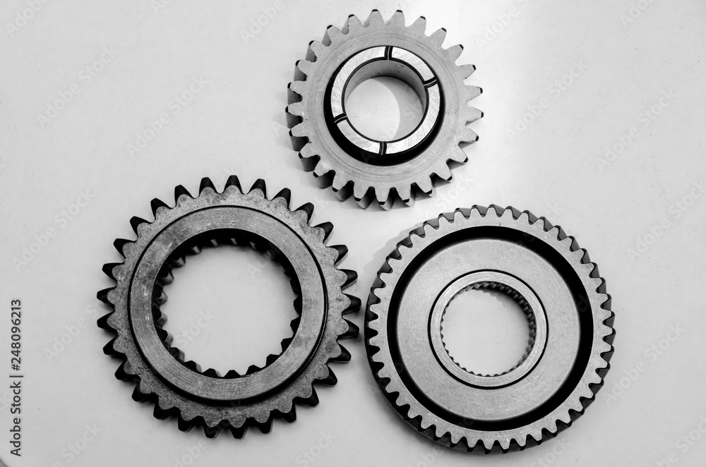 three different gears on the table, spare parts for the car three different gears on the table, spare parts for the car