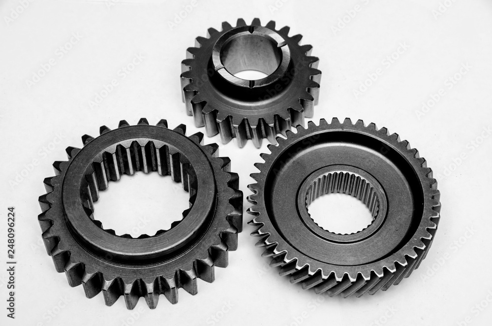 three different gears on the table, spare parts for the car three different gears on the table, spare parts for the car