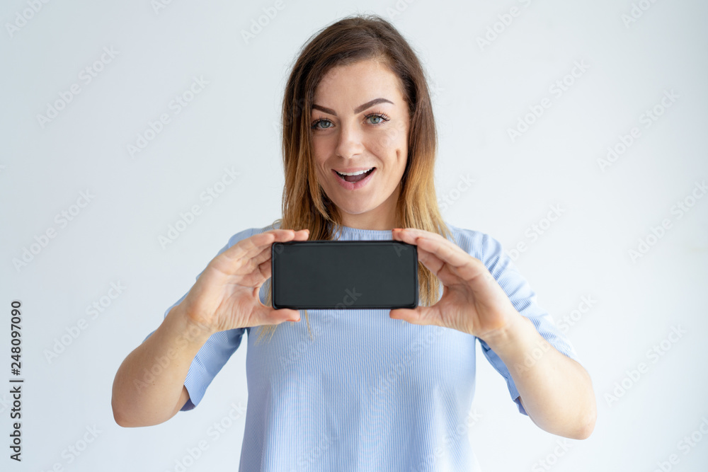 Cheerful woman showing smartphone screen Cheerful woman showing smartphone screen
