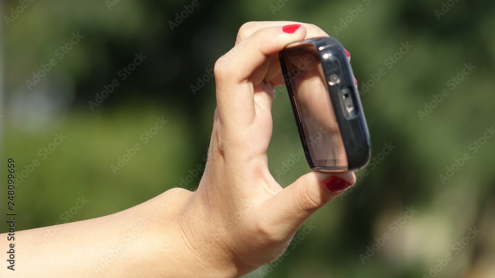 Fototapeta premium Female Hand Taking Photo With Phone