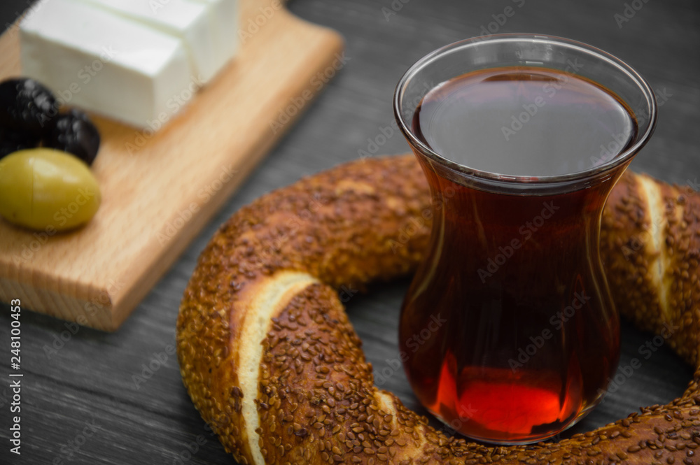 Turkish breakfast on black wooden table, black tea, bagels, olives, cheese. Turkish breakfast on black wooden table, black tea, bagels, olives, cheese.