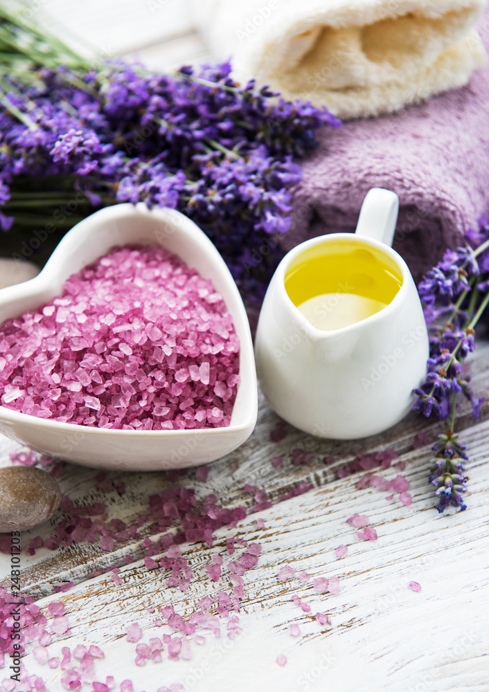 Heart-shaped bowl with sea salt, oils, soap and fresh lavender flowers on a wooden background Heart-shaped bowl with sea salt, oils, soap and fresh lavender flowers on a wooden background