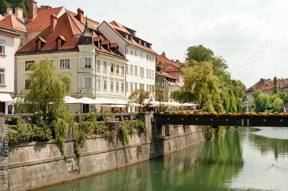 Popular restaurants and cafes along Cankarjevo nabrezje (embankment) of Ljubljanica river in the center of Ljubljana, Slovenia
