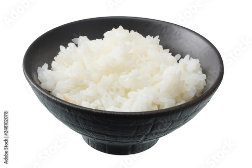 White rice in black bowl isolated on white background.