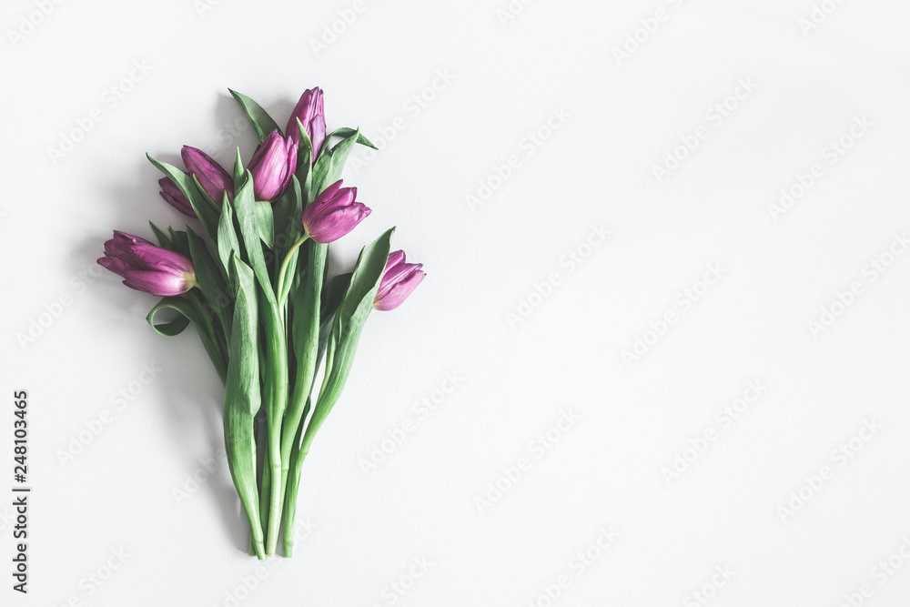 Flowers composition. Purple tulip flowers on pastel gray background. Valentines day, mothers day, womens day, spring, easter concept. Flat lay, top view, copy space Flowers composition. Purple tulip flowers on pastel gray background. Valentines day, mothers day, womens day, spring, easter concept. Flat lay, top view, copy space