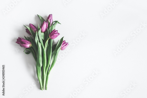 Flowers composition. Purple tulip flowers on pastel gray background. Valentines day, mothers day, womens day, spring, easter concept. Flat lay, top view, copy space