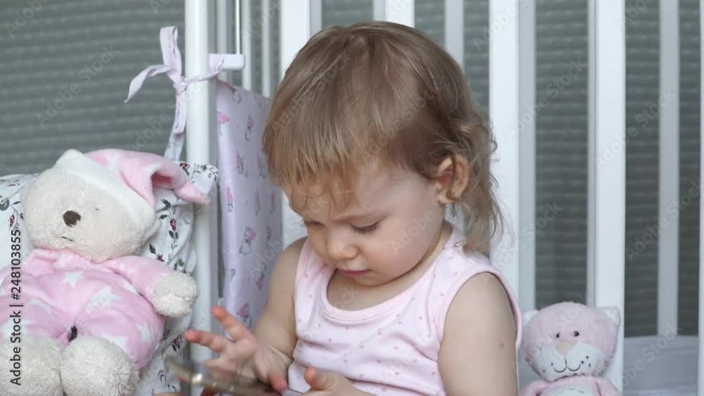 Little pretty girl with blue eyes touches the smartphone. Calling, talking, laughing and smiling Little pretty girl with blue eyes touches the smartphone. Calling, talking, laughing and smiling
