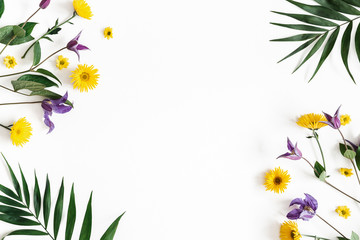 Flowers composition. Yellow and purple flowers on white background. Spring, easter concept. Flat lay, top view, copy space