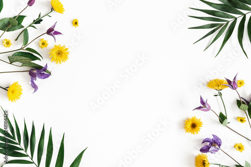 Flowers composition. Yellow and purple flowers on white background. Spring, easter concept. Flat lay, top view, copy space