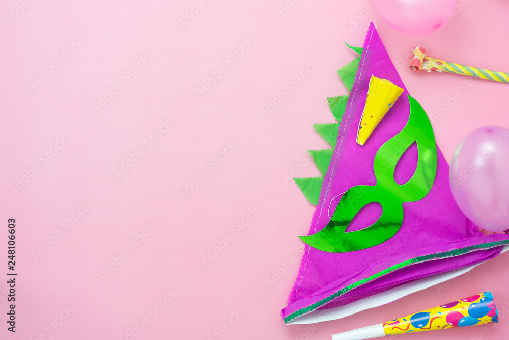 Table top view aerial image of beautiful colorful carnival season or photo booth prop Mardi Gras background.Flat lay objects colorful green mask with decorations to party on pink paper.space for text
