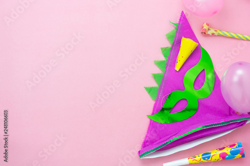 Table top view aerial image of beautiful colorful carnival season or photo booth prop Mardi Gras background.Flat lay objects colorful green mask with decorations to party on pink paper.space for text