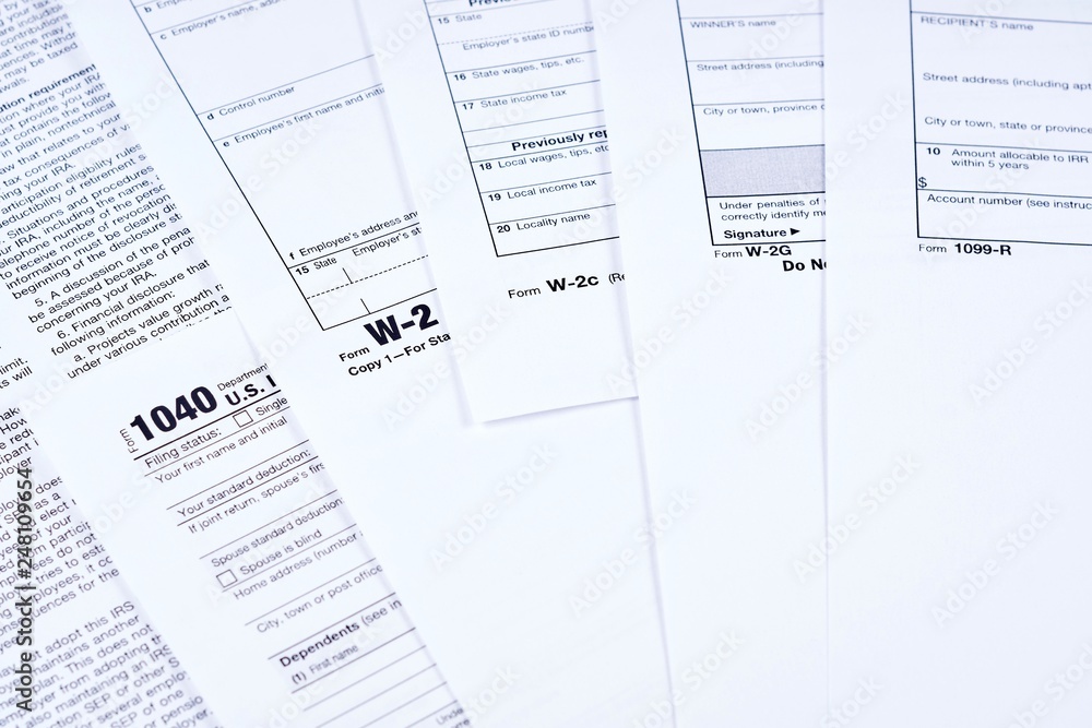 Fototapeta premium Tax Forms 1040, w-2, w-2c, w-2g, 1099r on background other forms